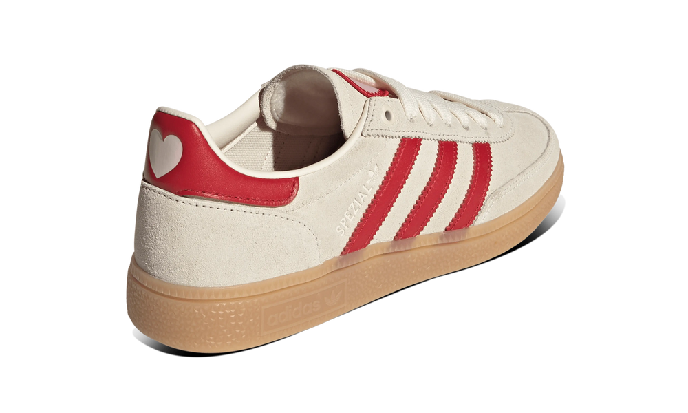 Adidas Handball Spezial sneakers in an off-white and red colorway,