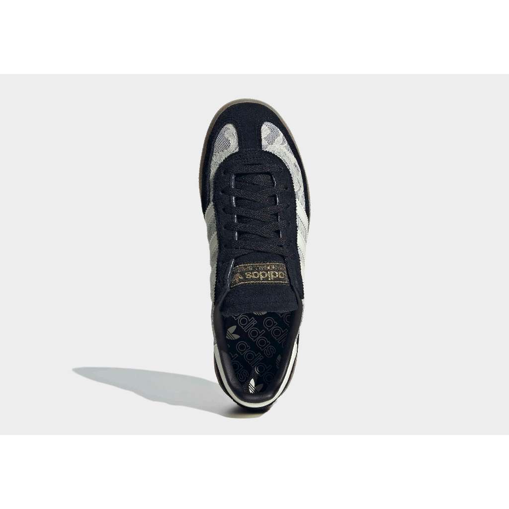 Adidas Handball Spezial sneakers in black with a white lace overlay.