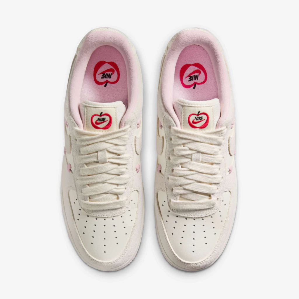 Nike Air Force 1 Low "Valentine's Day" sneakers featuring light beige suede overlays and small pink heart details along the Swoosh.